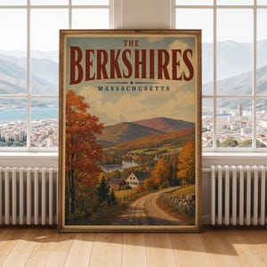 May include: A framed vertical wall art print featuring a landscape illustration of The Berkshires, Massachusetts. The image depicts a dirt road leading toward a house, a lake, and rolling hills with autumn foliage in shades of orange and red.