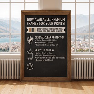 May include: A framed chalkboard-style sign with text promoting premium frames for prints. The sign features a wooden frame and lists features like shatter-resistant plexi glass, sawtooth hangers, and desktop or wall mount options. The available finishes are oak, black, or white.