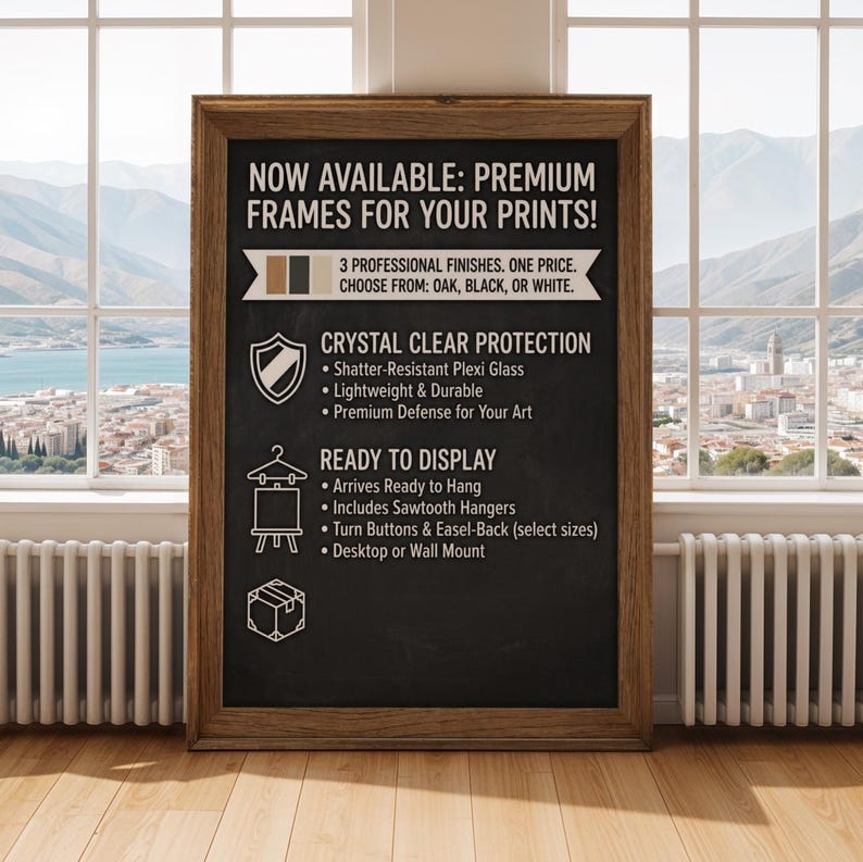 May include: A framed chalkboard-style sign with text promoting premium frames for prints. The sign features a wooden frame and lists features like shatter-resistant plexi glass, sawtooth hangers, and desktop or wall mount options. The available finishes are oak, black, or white.