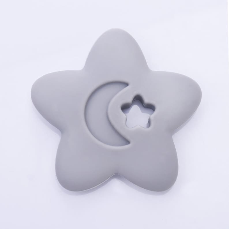 May include: A gray silicone baby teether shaped like a star with a crescent moon and a star cutout.
