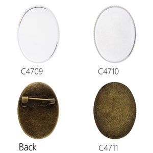 May include: Three oval-shaped metal blanks for making custom pins or brooches. The first two blanks are silver and the third is a bronze colour. The third blank has a pin back attached to it.