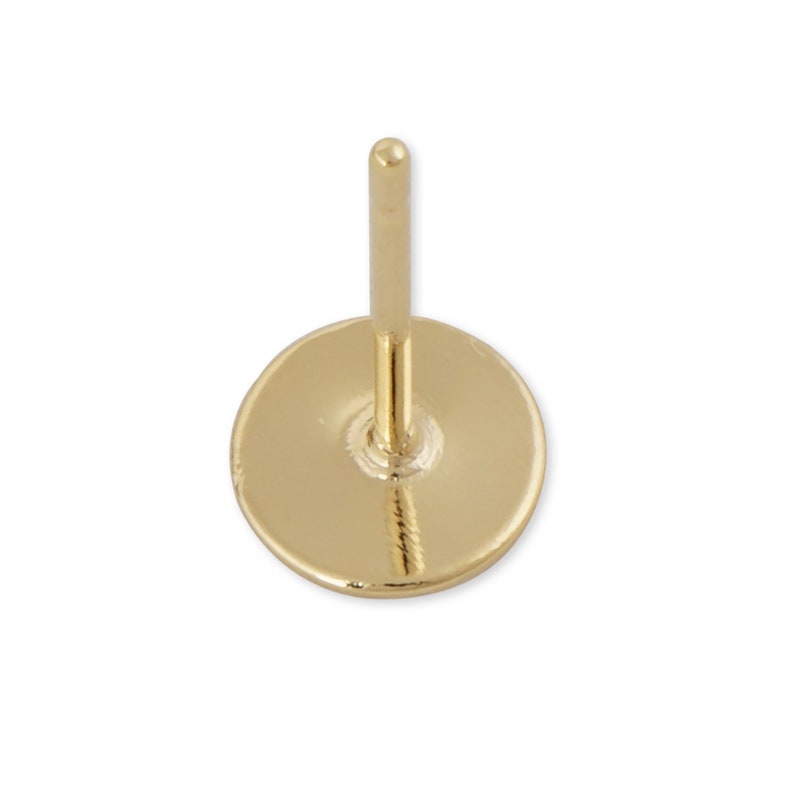 May include: Gold stud earring with a round back post. The earring is made of metal and has a shiny finish.
