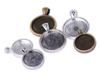 May include: Five round metal pendant trays with a decorative pattern. The trays are silver and bronze in color and have a loop at the top for hanging.