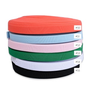 May include: A stack of six elastic bands in different colors: coral, light blue, pink, green, white, and black. Each band is labeled with a number, starting with #50 and ending with #55.