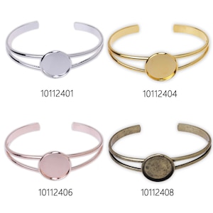 May include: Four different metal bangle bracelets with a round, flat, blank metal charm in the center. The bracelets are silver, gold, rose gold, and antique brass. The charms are all the same size and shape. The bracelets are all double-banded. The product numbers are 10112401, 10112404, 10112406, and 10112408.