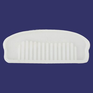 May include: White silicone mold shaped like a comb. The mold is designed to create a comb-shaped object.