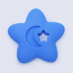 May include: A blue silicone teether shaped like a star with a crescent moon and a star cutout.