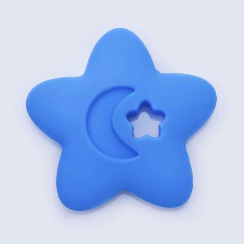 May include: A blue silicone teether shaped like a star with a crescent moon and a star cutout.