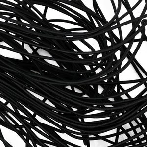 May include: A close-up of a bundle of black elastic cord. The cord is tightly wound together, creating a textured and interwoven pattern.