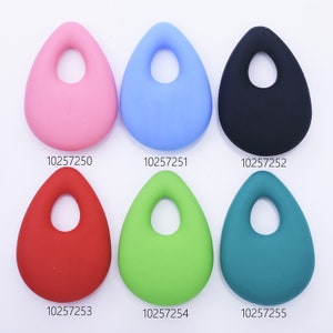 May include: Six teardrop-shaped silicone beads with a hole in the center. The beads are in different colors: pink, light blue, black, red, green, and teal.