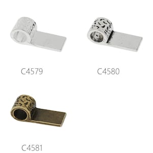 May include: Three silver and bronze metal end caps for jewellery making. The end caps have a decorative design and a hole for threading cord or string. The end caps are labelled C4579, C4580, and C4581.