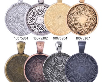 May include: Eight round metal pendant trays with different finishes: silver, antique silver, gold, antique gold, bronze, copper, gunmetal, and black. Each tray has a decorative swirl pattern and a bail for hanging.