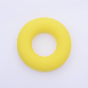 May include: A bright yellow rubber ring, similar to a life preserver, but smaller in size.