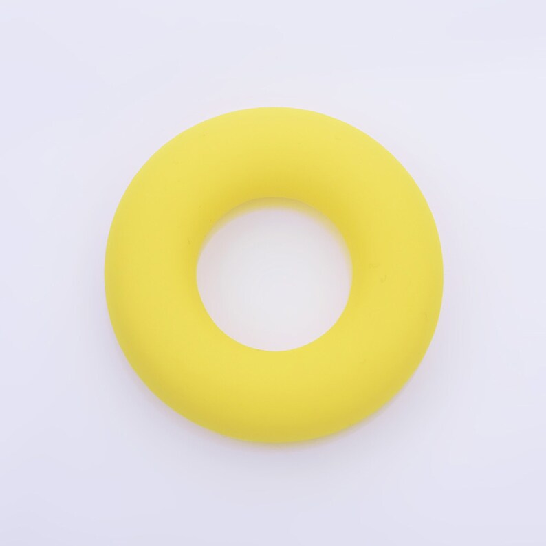 May include: A bright yellow rubber ring, similar to a life preserver, but smaller in size.
