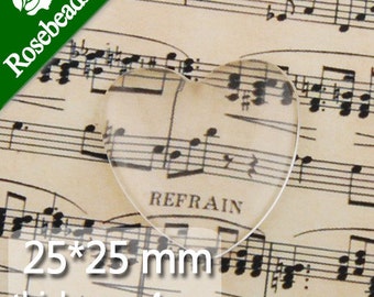 May include: Clear glass heart-shaped cabochon measuring 25mm by 25mm with a thickness of 4mm. The cabochon is sitting on a sheet of music with the word "Refrain" printed on it.