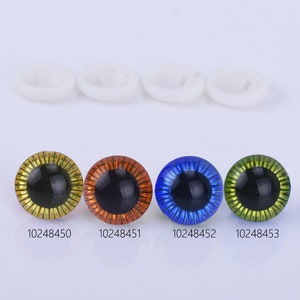 May include: Four plastic safety eyes with black pupils and different colored rims: gold, orange, blue, and green. The eyes are 12mm in diameter.