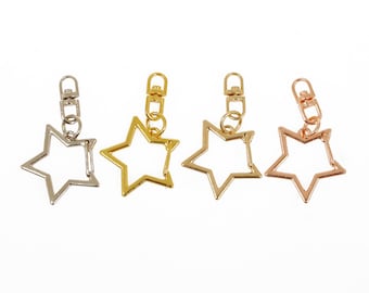 May include: Four star-shaped keychains in silver, gold, rose gold, and copper.