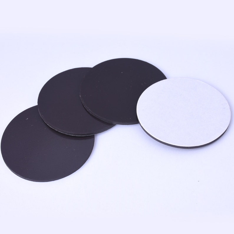May include: Four round black magnetic discs and one round white adhesive disc. The discs are approximately 2 inches in diameter.
