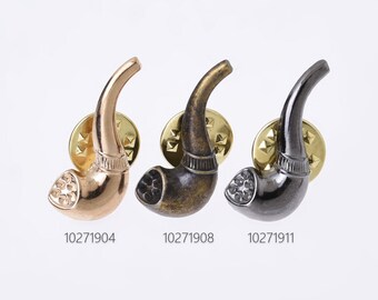 May include: Three metal pipe-shaped lapel pins in gold, bronze, and gunmetal gray. Each pin has a textured bowl and a curved stem, mounted on a gold-colored starburst backing. The product codes are visible below each pin.