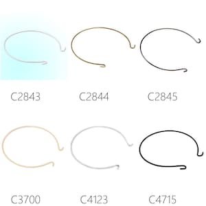 May include: Six metal hoops with different finishes, including silver, gold, and black. The hoops are all the same size and shape, and they have a small hook on one end.