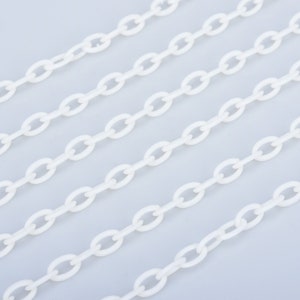 May include: White plastic chain links arranged in parallel lines on a light grey background.