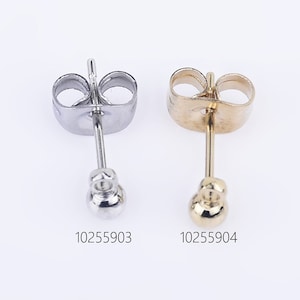 May include: Two earring backs, one silver and one gold. The silver earring back has a ball-shaped post and the gold earring back has a ball-shaped post. The earring backs are both designed to be worn on the back of an earring.