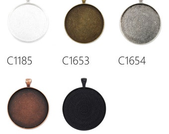 May include: Five round metal pendant trays in different colors: silver, bronze, gray, copper, and black. The trays have a textured surface and a loop at the top for hanging.