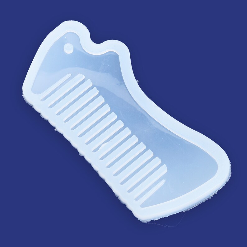 May include: A clear silicone mold shaped like a comb. The mold is designed to create a comb-shaped object.