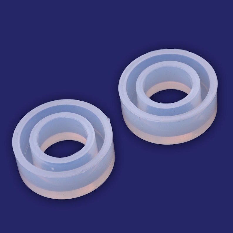 May include: Two clear silicone molds for making resin rings. The molds are nested, with a smaller inner ring and a larger outer ring.