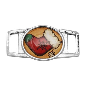 May include: Silver shoe charm with a round, colorful image of a Christmas stocking with a green top and white fur trim.