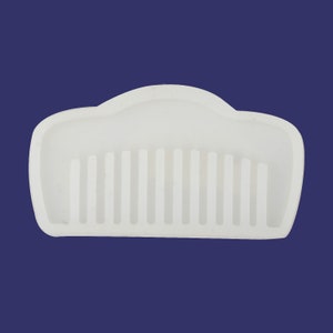 May include: White plastic comb with a rounded top and a row of teeth.