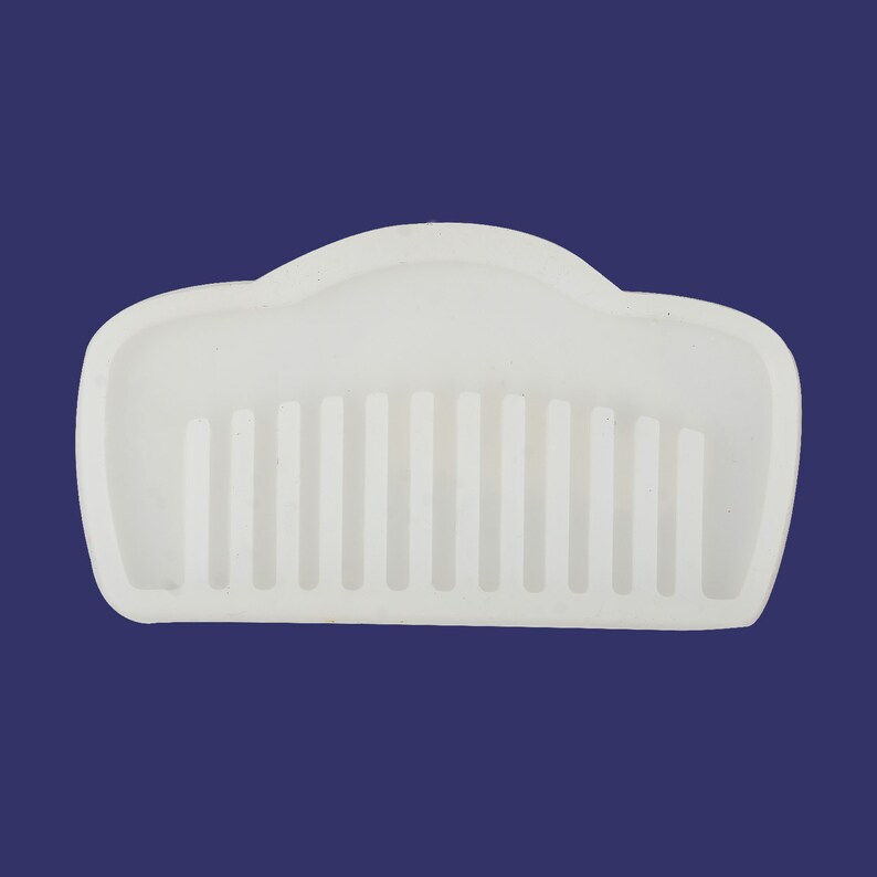 May include: White plastic comb with a rounded top and a row of teeth.