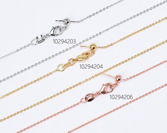May include: Three delicate chain necklaces in silver, gold, and rose gold. Each chain has a lobster clasp and a small ball at the end. The chains are labelled with the product numbers 10294203, 10294204, and 10294206.