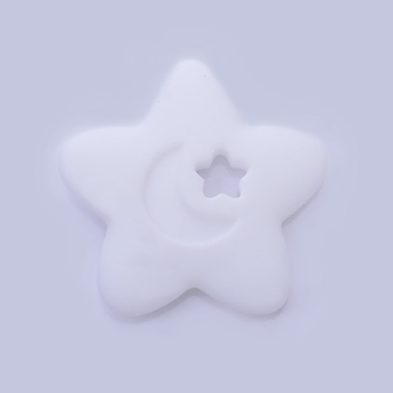 May include: A white silicone star-shaped baby teether with a crescent moon and star cutout.