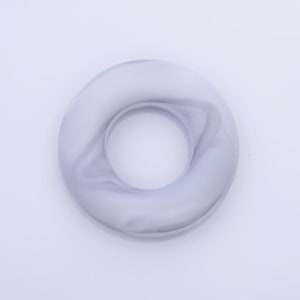 May include: A white and gray marble ring with a smooth, glossy finish.