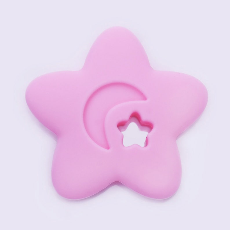 May include: A pink silicone baby teether shaped like a star with a crescent moon and a smaller star cut out.