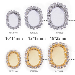May include: Six oval-shaped rhinestone embellishments with clear and gold settings. The embellishments are in two rows of three. The top row has silver settings and the bottom row has gold settings. The embellishments are 10mm x 14mm, 13mm x 18mm, and 18mm x 25mm.
