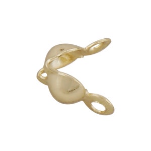May include: Gold-toned metal bead cap with two loops for attaching to jewelry.