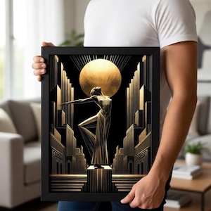 A man is holding a framed artwork featuring an artistic depiction of a woman in a golden dress standing in front of a cityscape with a large sun in the background.