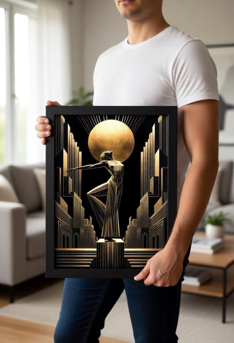 A man is holding a framed artwork featuring an artistic depiction of a woman in a golden dress standing in front of a cityscape with a large sun in the background.
