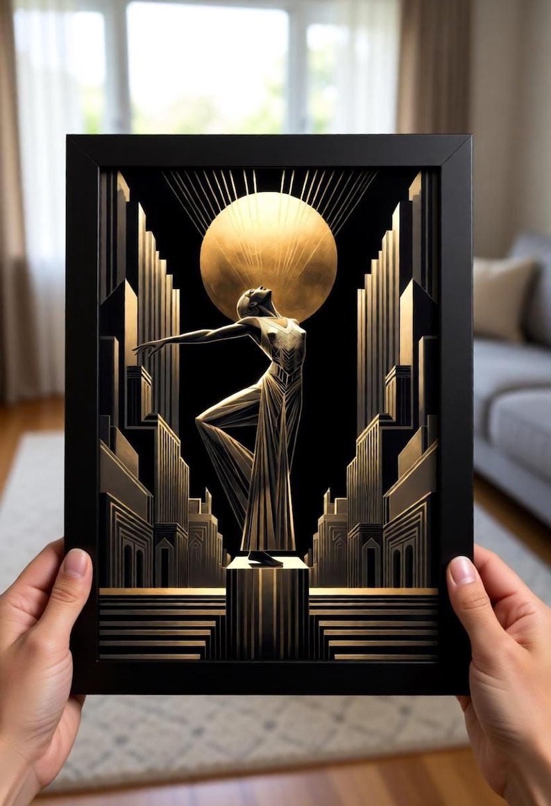 A person is holding up a framed artwork depicting an Art Deco-style scene with a stylized figure in the center, surrounded by architectural elements and a large sun-like object.