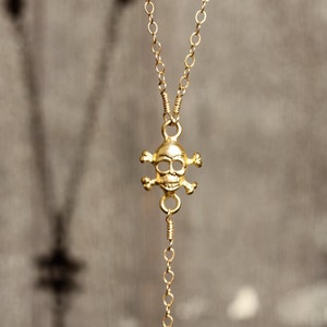 Rock Steady. Gold Rosary Necklace. Gold Skull Charm Blue Topaz