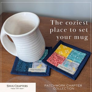 May include: White ceramic mug with a curved handle rests on two patchwork coasters. The coasters feature a square design with various fabric patterns in blue, yellow, and pink, framed by a navy blue border. Text on the coasters reads "Snug Chapters Co."