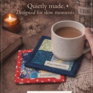 May include: A white ceramic mug with a black handle and the text "But First, Coffee" in a bold, black font. The mug is set against a blurred background, suggesting a cozy setting. The mug appears to be approximately 4 inches tall.