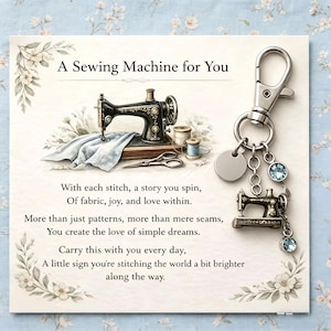 May include: A card featuring the text "A Sewing Machine for You" and a vintage sewing machine illustration. A silver keychain with a sewing machine charm and blue crystal accents hangs from the card. Floral accents decorate the card.