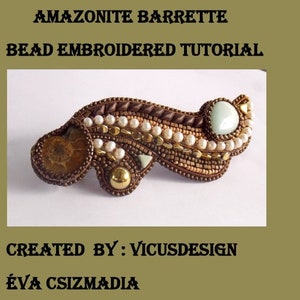 May include: A beaded barrette with a brown, gold, and white design. The barrette features a large green stone and a brown stone with a swirling pattern. The text "AMAZONITE BARRETTE BEAD EMBROIDERED TUTORIAL CREATED BY: VICUSDESIGN ÉVA CSIZMADIA" is visible in the image.