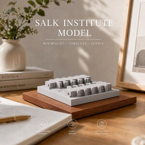 May include: A gray cement architectural model of the Salk Institute featuring a symmetrical structure with repeating rectangular sections, mounted on a square wooden base. The text SALK INSTITUTE MODEL is visible above the object.