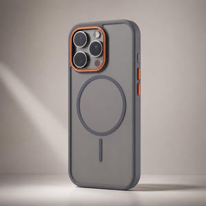 Puede incluir: Funda de teléfono gris con detalles en naranja alrededor de la cámara y los botones. La funda tiene un diseño circular en la parte posterior y una función de carga magnética. La funda está diseñada para proteger el teléfono.