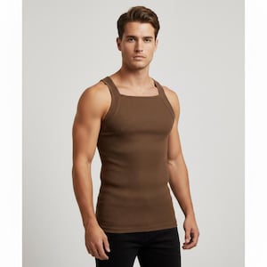 May include: A brown ribbed vest top with a square neckline. The sleeveless top is made of a soft, textured fabric. The model is wearing black trousers. This is a casual, everyday top.