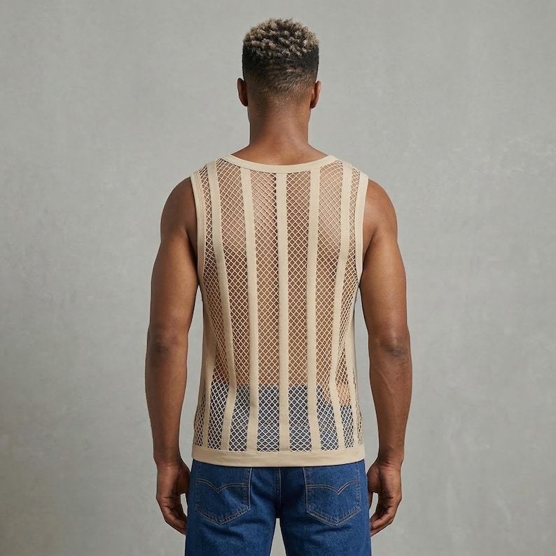 May include: Tan sleeveless tank top with a vertical striped net design. The top is made of a light, breathable material. The model is wearing blue jeans.